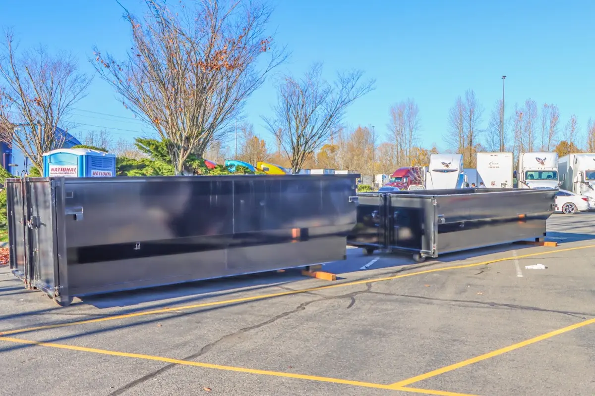 Professional dumpster rental service with roll-off container on residential driveway in Calimesa